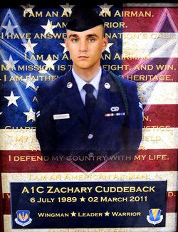 Memorial portrait of Airman First Class Zachary Cuddeback in dress uniform in front of the American flag and the Airman's Creed